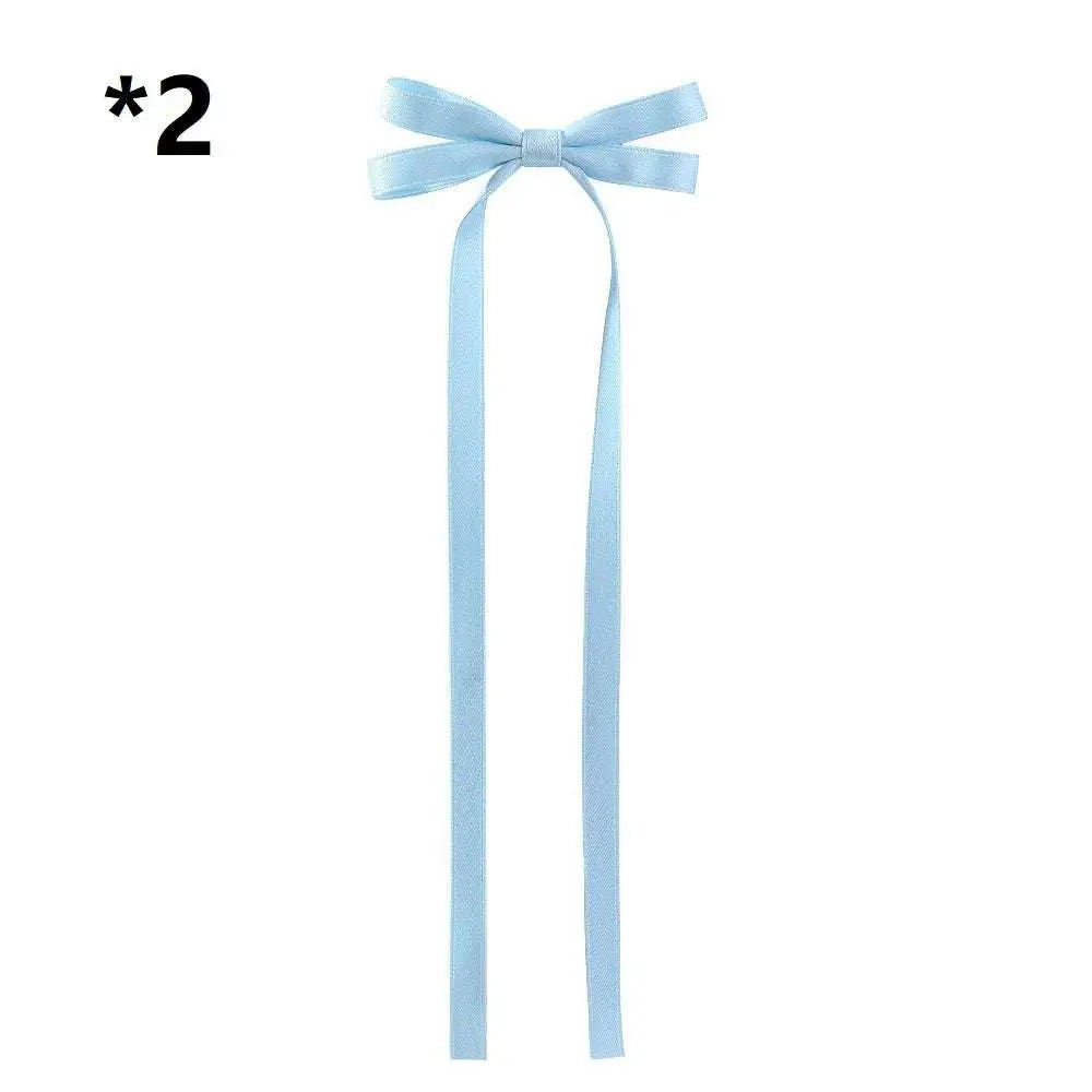 A light blue satin bow braided hair ribbon tie set featuring a delicate satin bow with long flowing tails