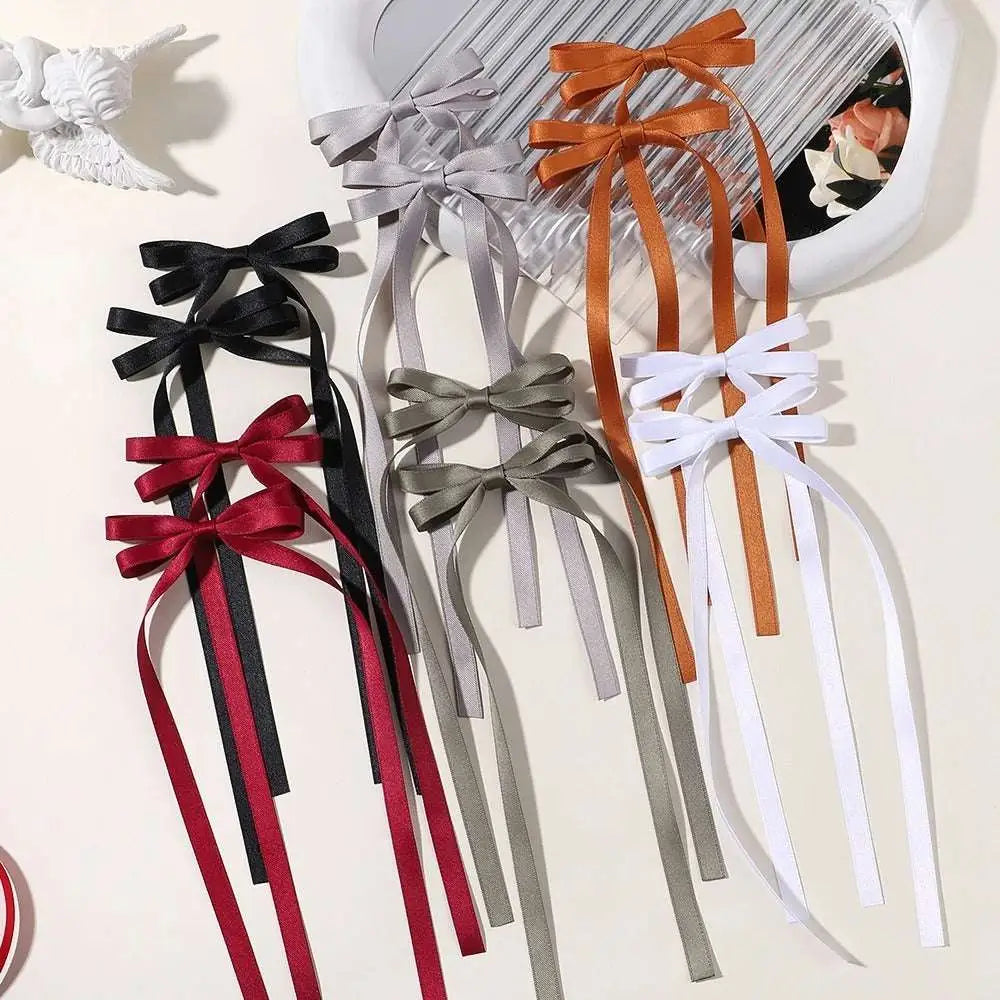 A set of satin bow braided hair ribbon ties in black red gray orange and white made of satin material