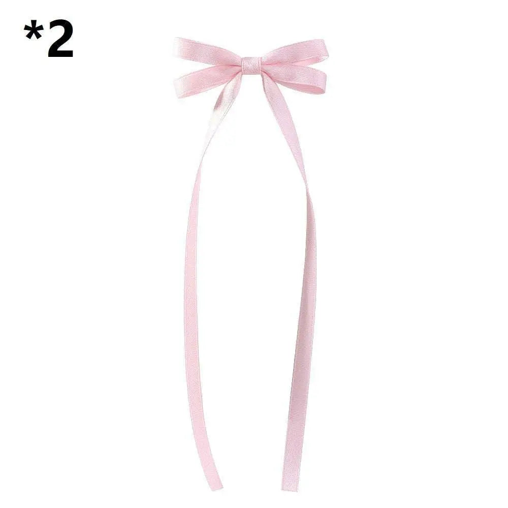 A delicate pink satin bow braided hair ribbon tie with long flowing tails for hair tie double styling