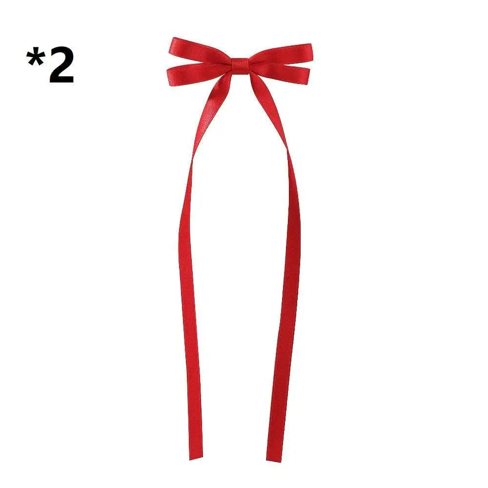 Red satin bow braided hair ribbon with long tails as a hair tie double for elegant braided hairstyles