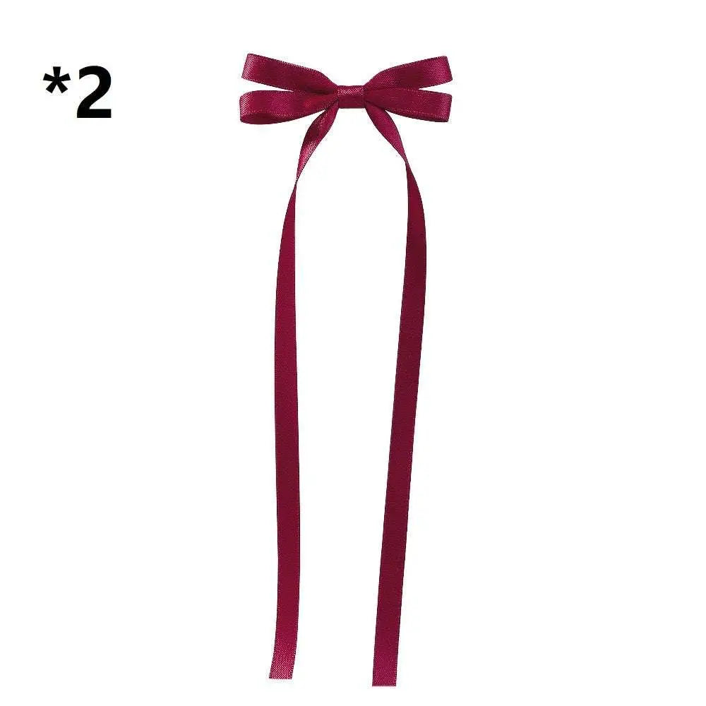 A pair of elegant deep burgundy satin bow braided hair ribbon ties with long tails for hair tie double styling