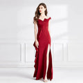 A flowing deep red satin evening dress with sweetheart neckline and high slit featuring asymmetrical ruffle detail