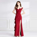 A sleek deep red satin evening dress with an off-the-shoulder neckline and a flattering high slit
