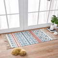 Scandinavian style linen cotton rug with tassels featuring a blue red and white geometric pattern in rectangular form