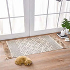 Beige and gray scandinavian style linen cotton rug with geometric pattern and decorative tassels for home decor