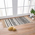 Scandinavian style linen cotton rug with black and cream geometric pattern and fringe tassels for home decor