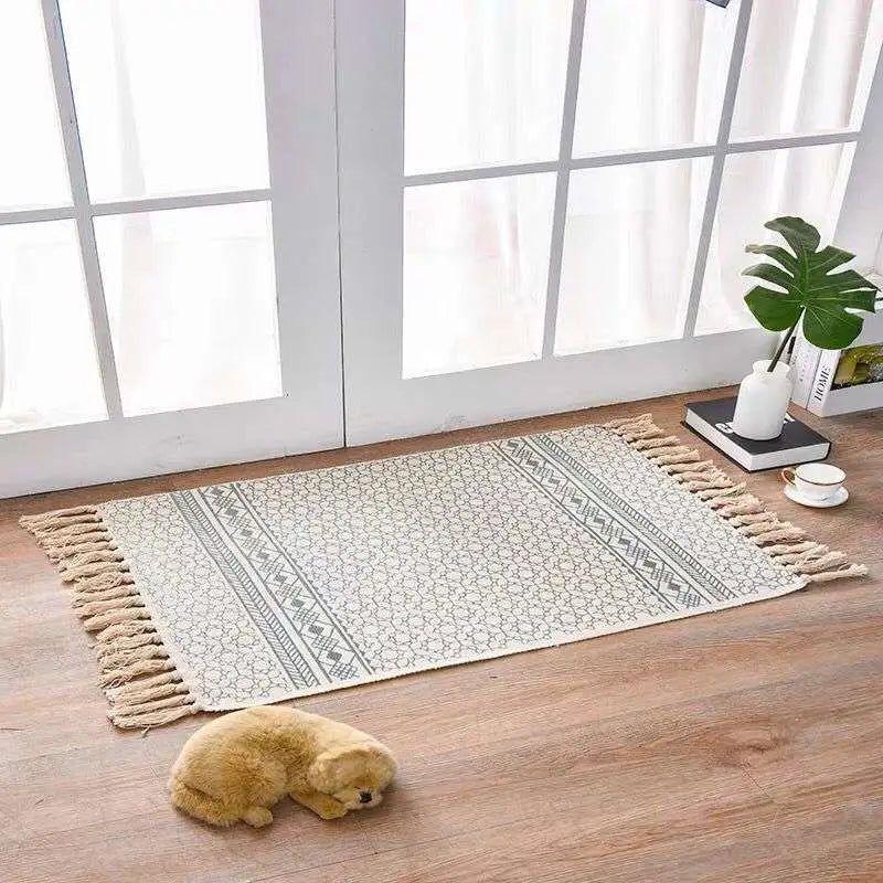 Scandinavian style linen cotton rug in beige with dark gray geometric pattern and cream-colored tassel fringe edges
