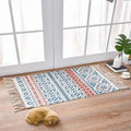 Rectangular scandinavian style linen cotton rug with blue red and white geometric pattern and tassel fringe edges