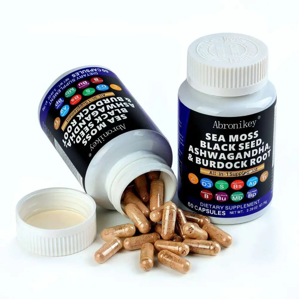 A bottle of abronikay sea moss and black seed oil capsules with ashwagandha extract and dark blue label white cap