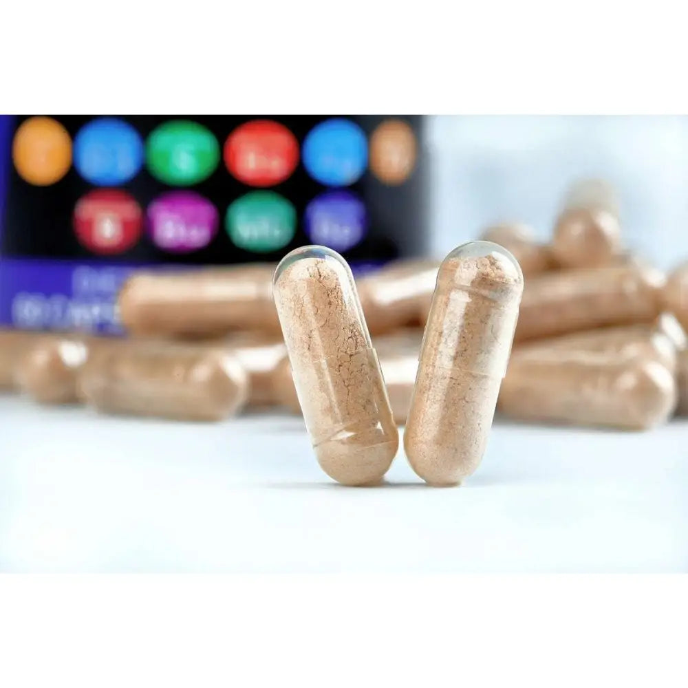 Two translucent beige capsules filled with fine light brown powder represent sea moss and black seed oil supplements
