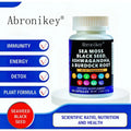 A white plastic bottle with a black label of Abronikay sea moss and black seed oil capsules featuring ashwagandha extract