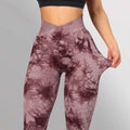 Purple and maroon seamless tie dye high waisted yoga leggings women with cross back design shown from the back side