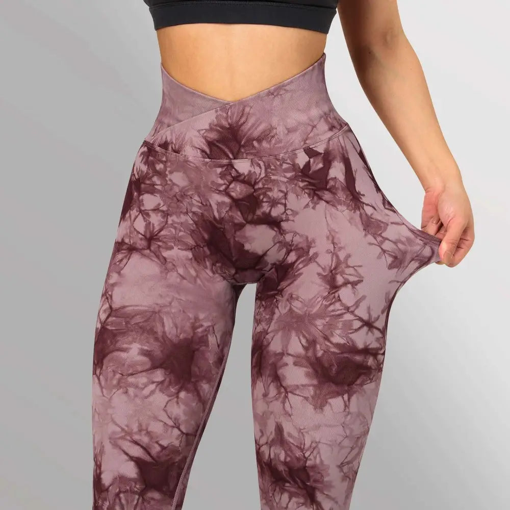 Purple and maroon seamless tie dye high waisted yoga leggings women with cross back design shown from the back side