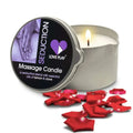 A lit silver tin seduction massage oil candle by Love Play with essential oils of lemon and clove and a purple heart logo