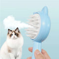 Light blue cat-shaped self-cleaning mist cat and dog grooming brush with white bristles for easy pet grooming