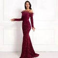 A sequined off-the-shoulder burgundy feather fishtail gown with sparkling details for formal events