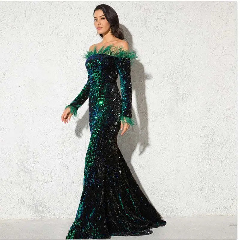 Emerald and black sequined off-the-shoulder fishtail gown with burgundy feather shoulder accents for formal events
