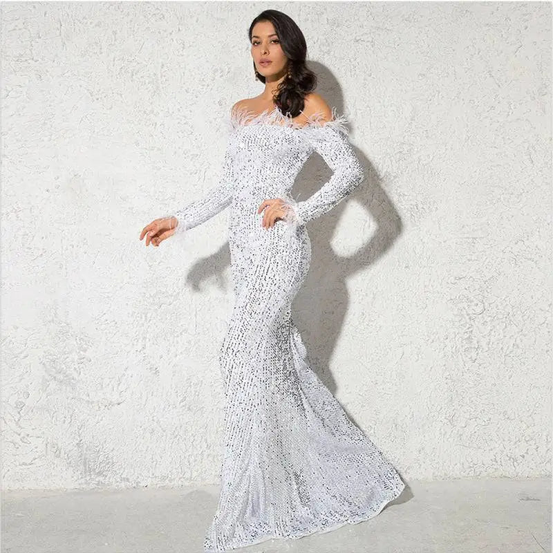 A shimmering white mermaid-style gown with long sleeves and feathered shoulder accents in burgundy feather fishtail design