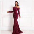A shimmering burgundy feather fishtail party formal dress with long sleeves and sequined off-the-shoulder detail