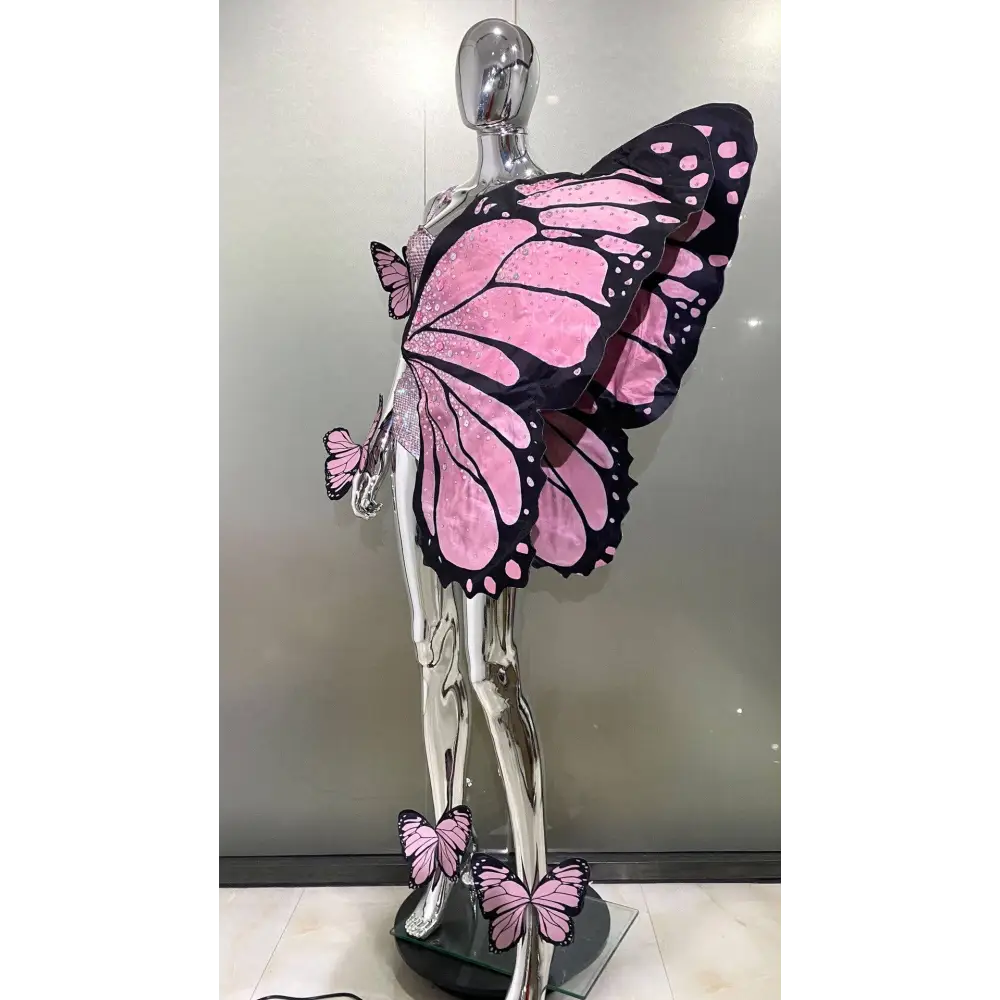 Sequin butterfly latin dance skirt dress with pink and black butterfly wings on chrome mannequin made of net yarn stretch