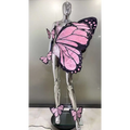 Chrome mannequin adorned with pink and black sequin butterfly latin dance skirt dress featuring glittery texture wings