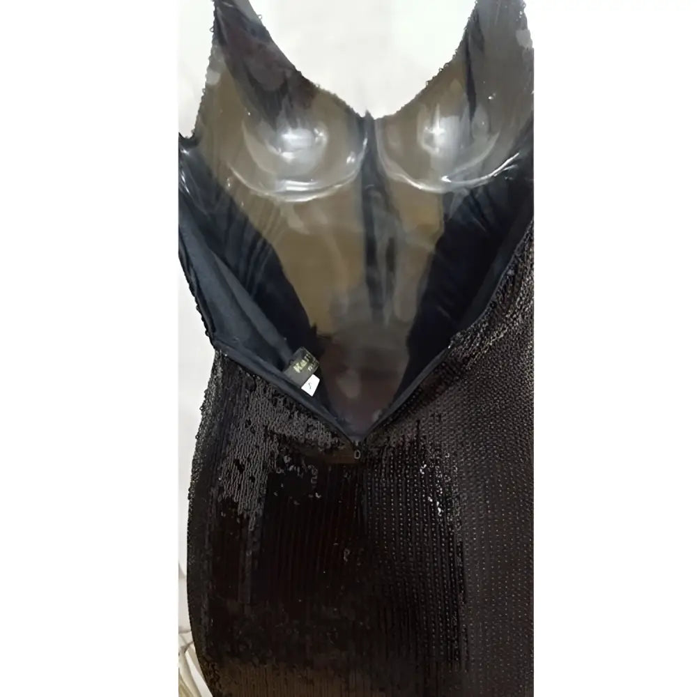 A black sequined fringed backless slip dress featuring a plunging neckline and sheer mesh straps