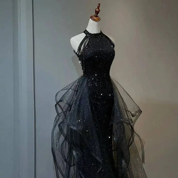 Black sequined halter neck evening dress with layered sheer tulle overlay and flowing tulle skirt for formal occasions