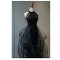 Black sequined halter neck evening dress with layered sheer tulle overlay and flowing tulle skirt for formal events