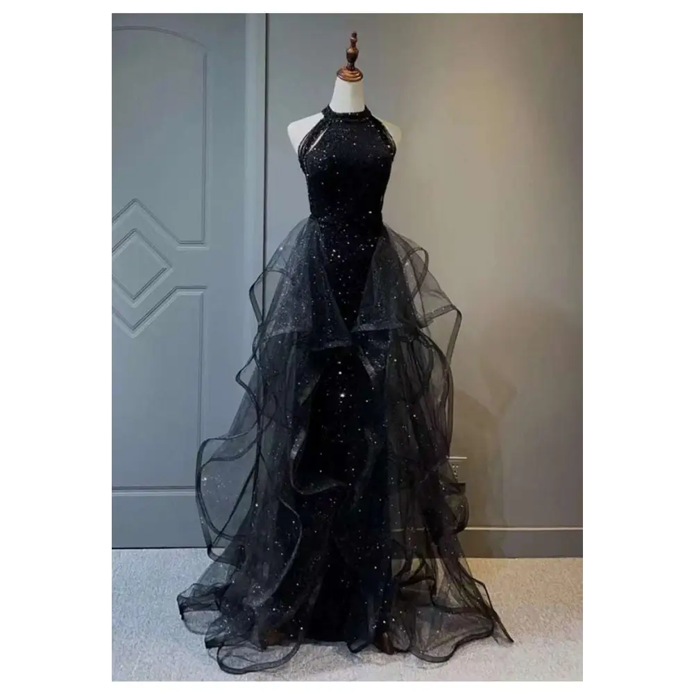 Black evening dress featuring a sequined halter neck and layered sheer tulle skirt with elegant tulle layers
