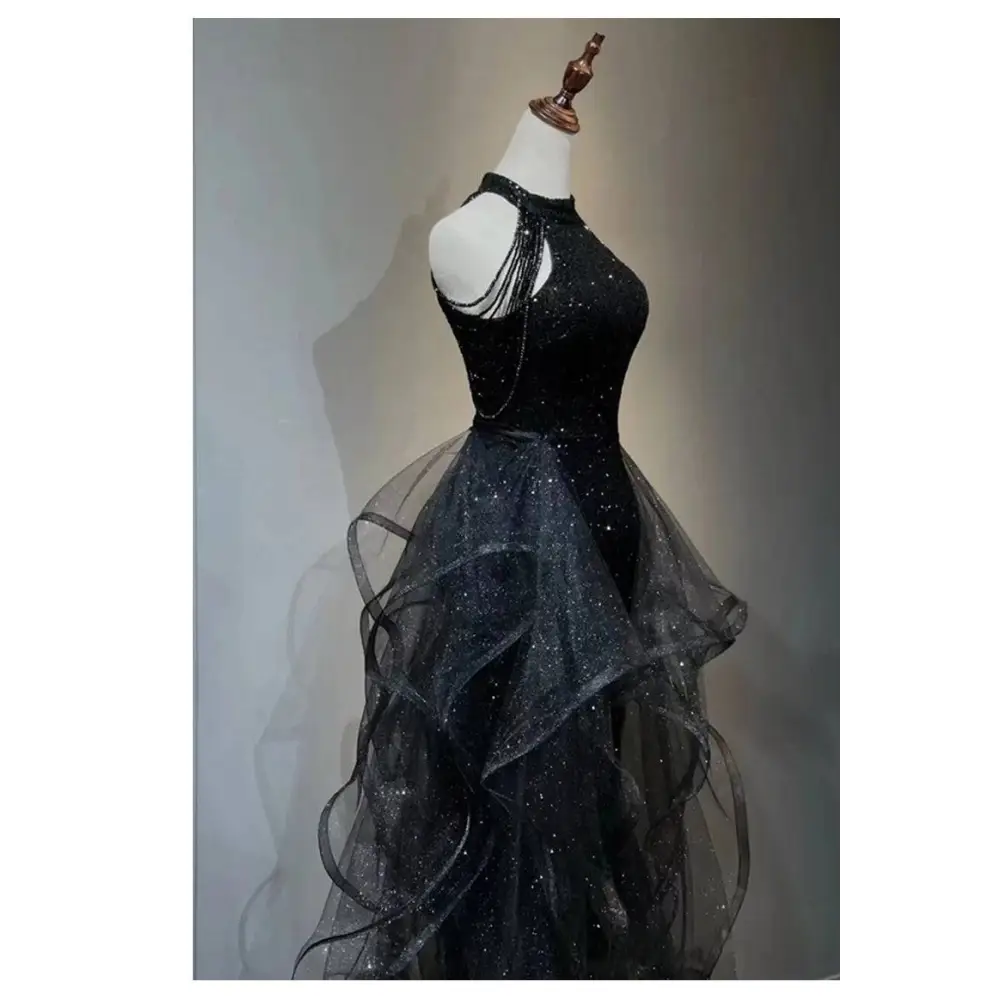Black evening dress with sequined halter neck and layered sheer tulle skirt for elegant formal occasions