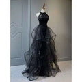Black evening dress featuring a sequined halter neck and layered sheer tulle skirt for formal occasions