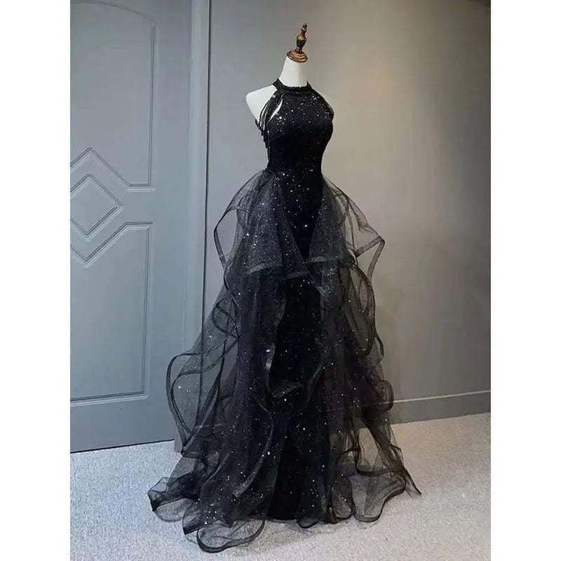 Black evening dress featuring a sequined halter neck and layered sheer tulle skirt for formal occasions