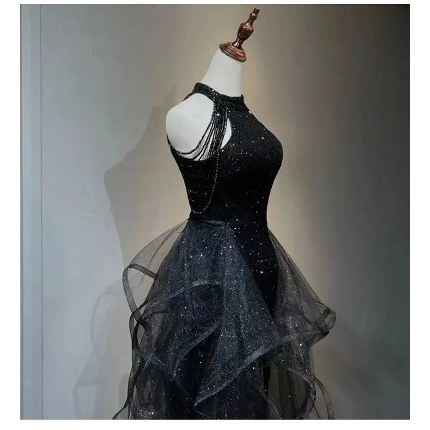Black sequined halter neck evening dress with layered sheer tulle skirt and delicate beaded straps