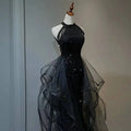 Black sequined halter neck evening dress featuring layered sheer tulle overlay and tulle skirt for formal occasions