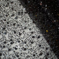 Black and silver sequined mesh fabric showcasing pearl embroidery lace for a lace asymmetric dress with dazzling gold sequined accents