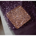 A square wooden tray decorated with shimmering purple and silver sequins showcasing pearl embroidery lace design