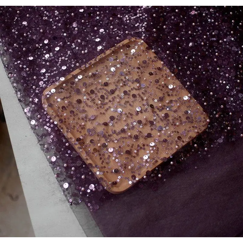 A square wooden tray decorated with shimmering purple and silver sequins showcasing pearl embroidery lace design