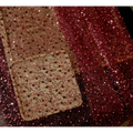 A shimmering rose gold sequined phone case with clear base and intricate beadwork paired with lace asymmetric dress