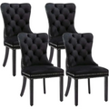 Set of 4 black velvet tufted dining chairs with silver nailhead trim featuring velvet fabric upholstery