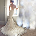 Ivory mermaid wedding dress with intricate lace detailing and beaded back featuring a long trailing train for brigade shooting seaside events