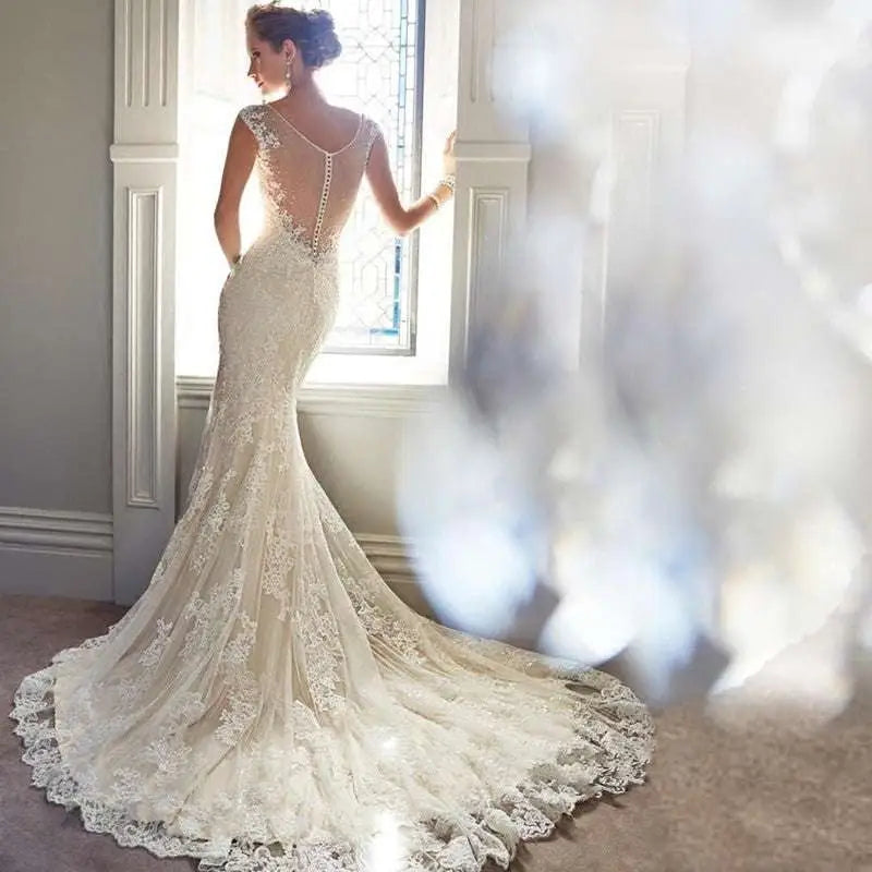 Ivory mermaid wedding dress with intricate lace detailing and beaded back featuring a long trailing train for brigade shooting seaside events