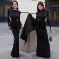 Black long sleeve dress featuring a form-fitting design with a dramatic twisted knot at the waist for a sexy look