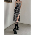 Black and white leopard print satin slip dress with fitted bodice, thin straps, high slit, and leopard print chain detail
