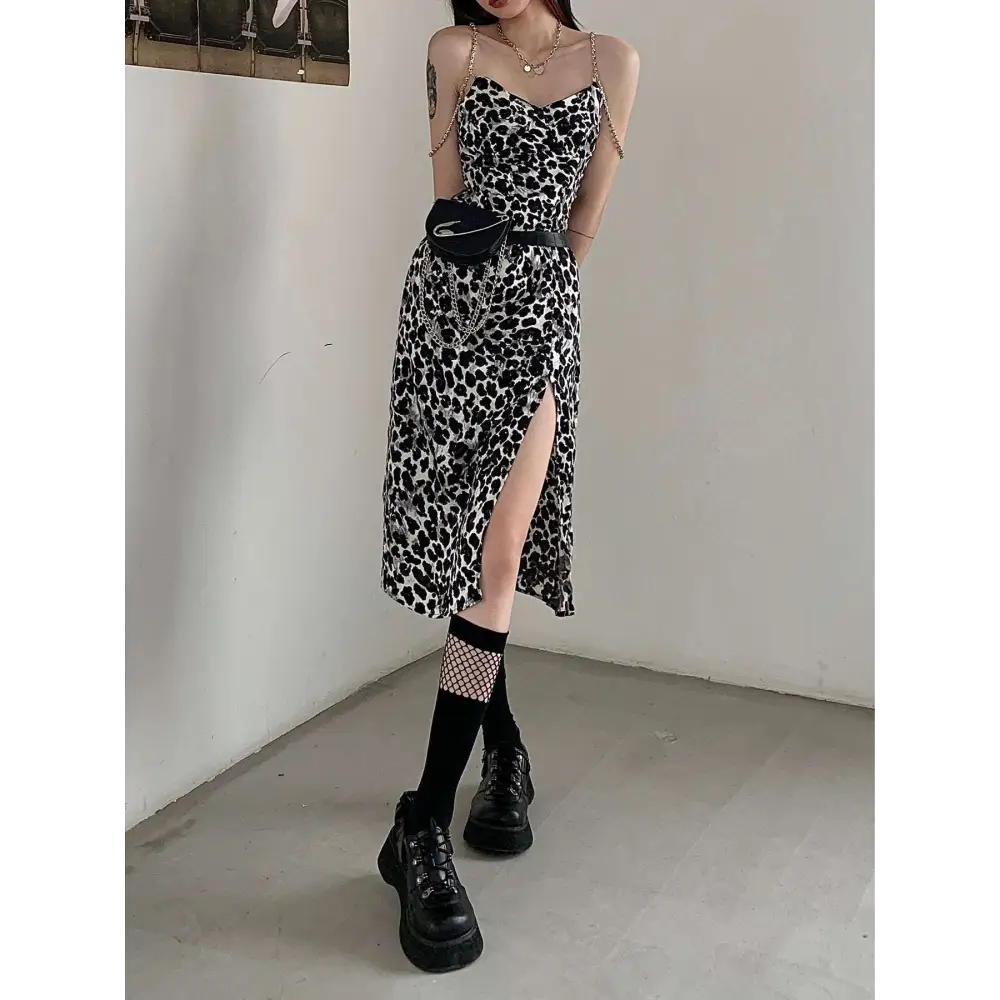 Black and white leopard print satin slip dress with fitted bodice, thin straps, high slit, and leopard print chain detail