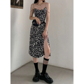 Black and white leopard print satin slip dress with thin spaghetti straps and side slit featuring leopard print chain detail