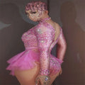 A sparkling pink sequined shiny rhinestone mesh performance leotard with sheer overlay and ruffled tulle skirt