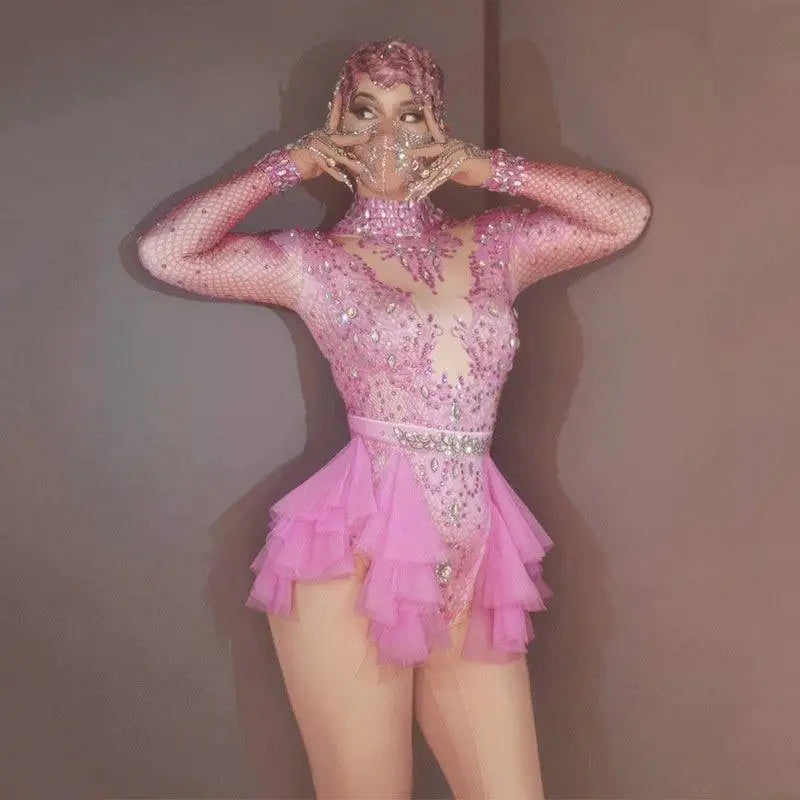 A sparkling pink sequined shiny rhinestone mesh leotard with tiered tulle skirt and matching headpiece for performance