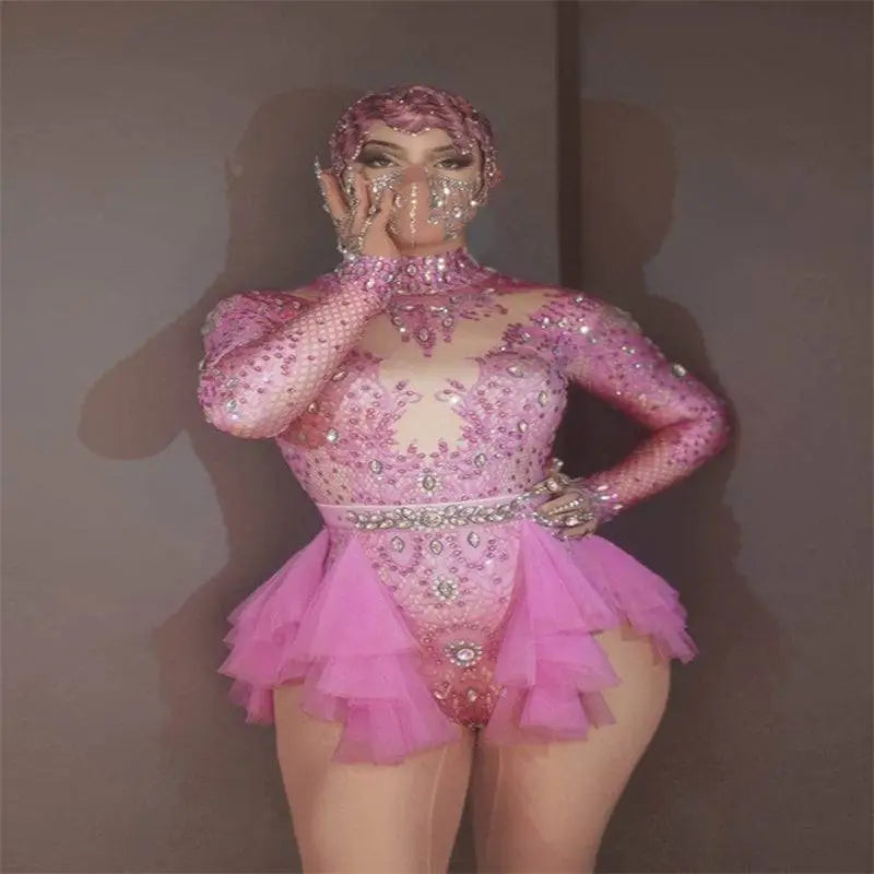 A sparkling pink sequined shiny rhinestone mesh performance leotard with ruffled tulle skirt and matching headpiece