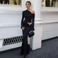 Black one-shoulder long-sleeve floral mermaid dress with gold embellishments and flared skirt for elegant occasions