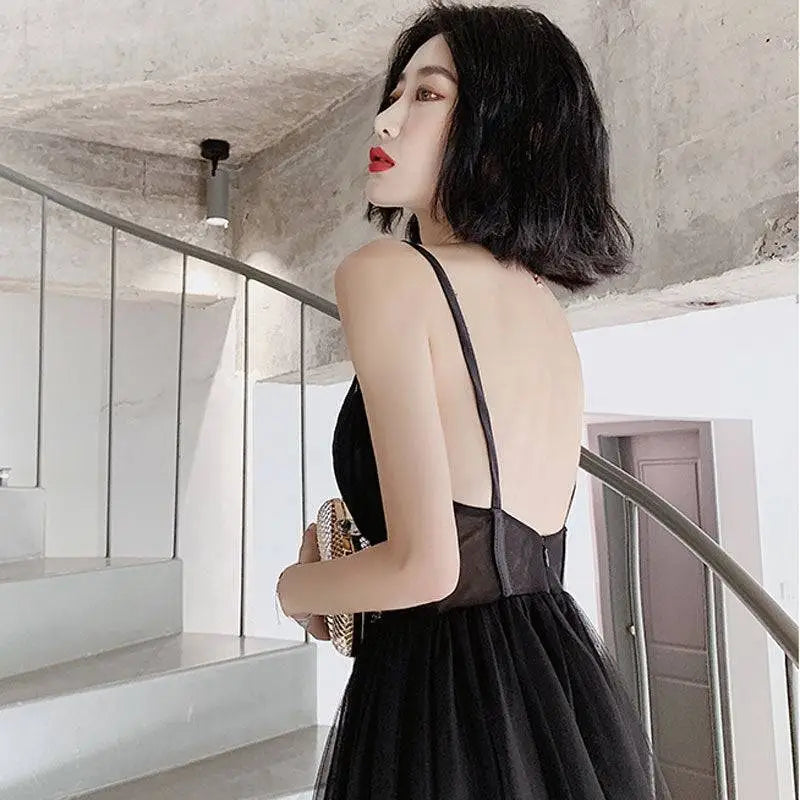 Black lace backless sexy suspenders gauze evening dress with thin straps and sheer mesh overlay flowing skirt view from back